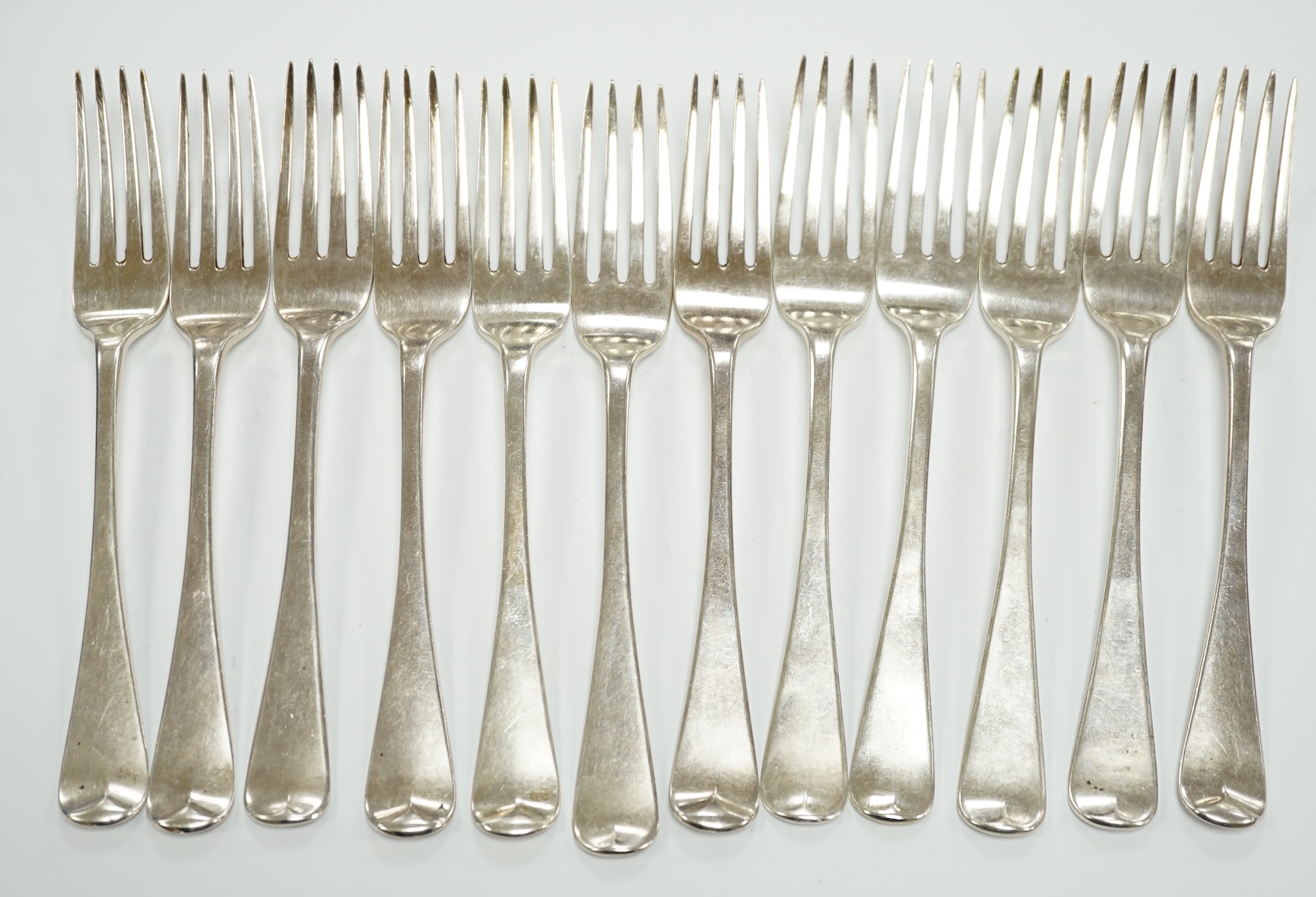 A set of six George IV silver table forks, London, 1824 and a later similar Victorian set, London, 1837, 25.8oz.